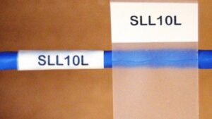 Wire tag wrap-around label on cable showing clear wire identification code in industrial wiring system